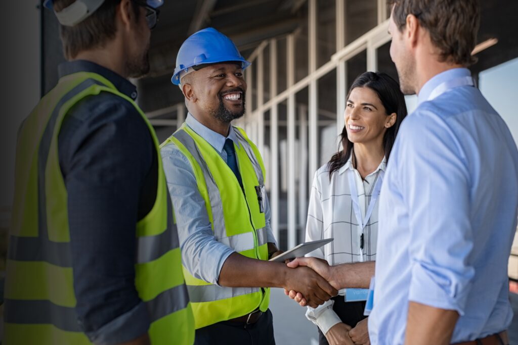 A handshake between a construction company and a couple.